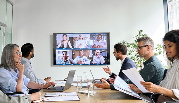 a group of coworkers sitting around a conference table having a meeting