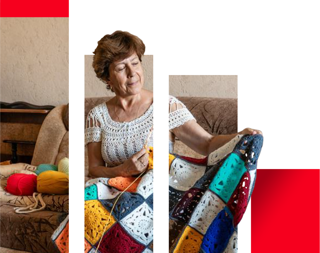 Woman sitting on the couch knitting a blanket