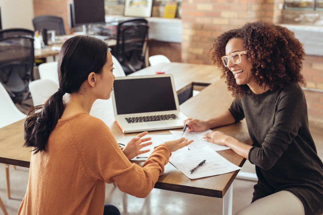 Two women having a meeting around a laptop