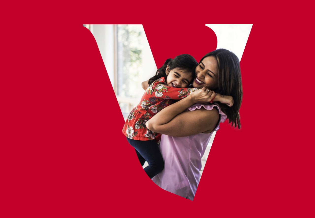 mother/daughter hugging behind a Vanguard V