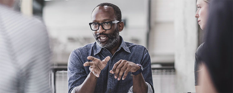 a man talking to a group of people