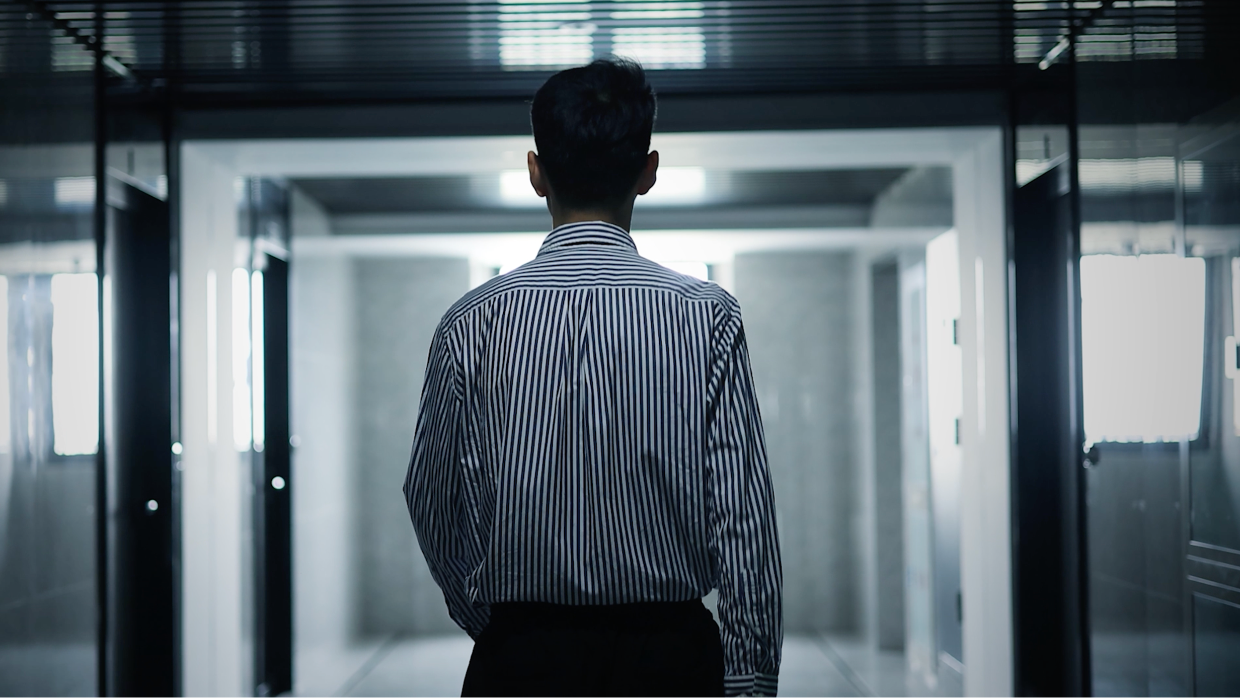 a man walking down a hallway