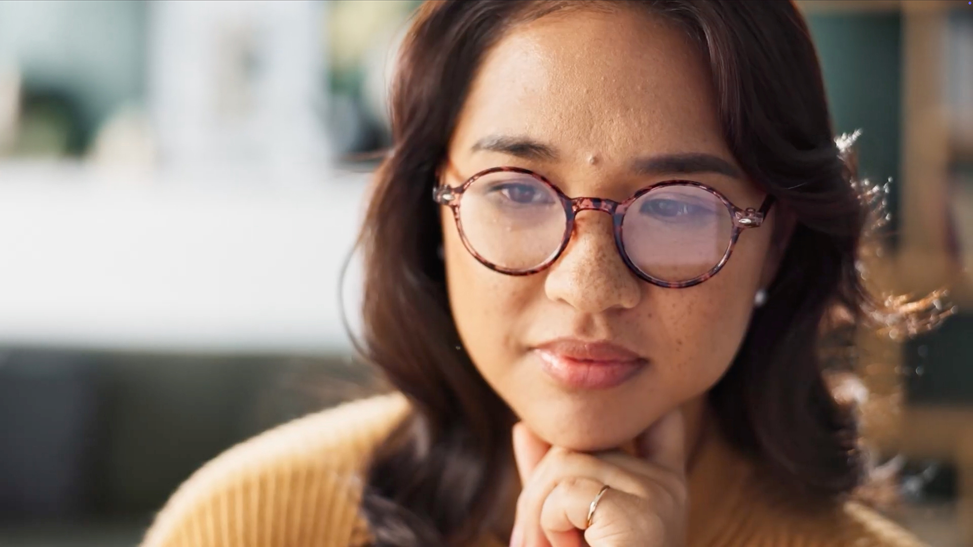 a woman with glasses staring