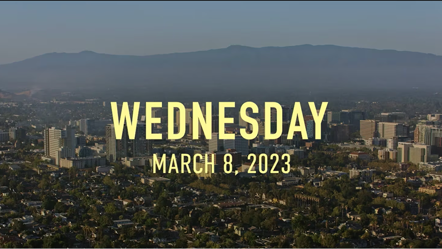 A city background with Wednesday March 8, 2023 in yellow letters