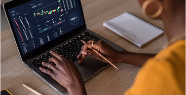 woman looking at a stock chart on a laptop