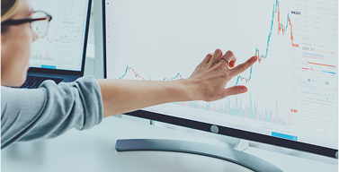a man looking at a graph on a computer monitor