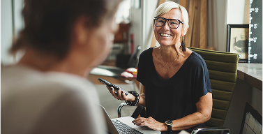 woman laughing with another woman